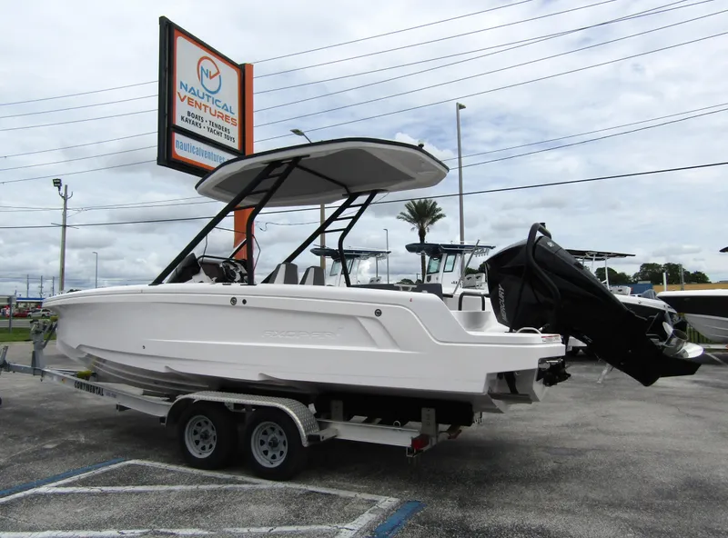 Slide: The Image of 2022 Axopar 22 T-Top boat on trailer at dealership parking lot. - 1