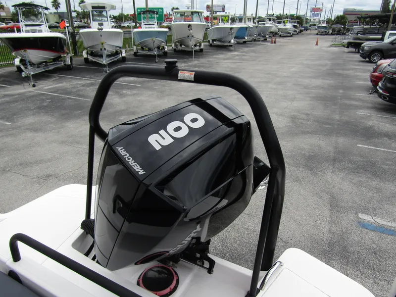 Slide: The Image of 2022 Axopar 22 T-Top with Mercury 200 outboard engine in a boat dealership. - 18