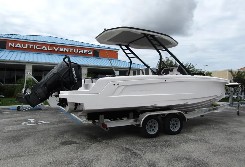 Slide: The Image of 2022 Axopar 22 T-Top boat on trailer at Nautical Ventures dealership. - 2