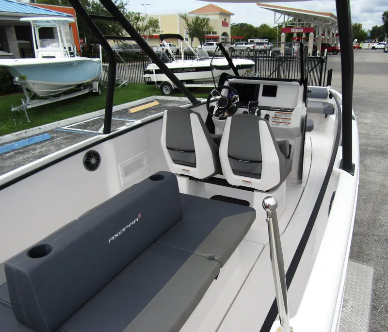 Slide: The Image of 2022 Axopar 22 T-Top boat interior with seating and steering console. - 20