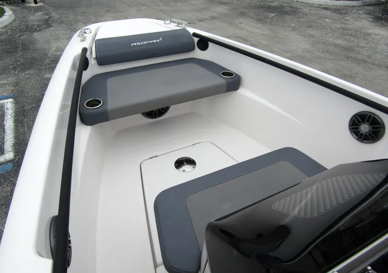 Slide: The Image of 2022 Axopar 22 T-Top boat interior with seating and cup holders. - 8