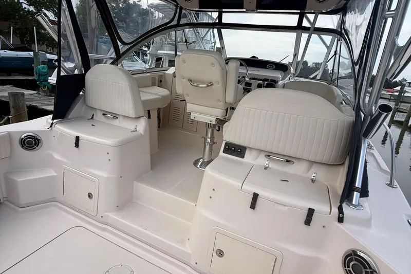 Slide: The Image of 2013 Grady-White Express 330 boat interior with white seating and steering area. - 12