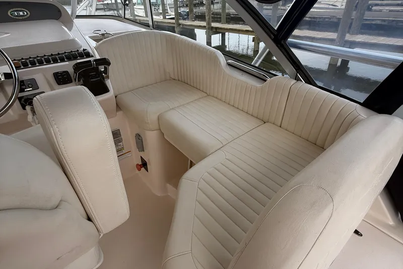 Slide: The Image of 2013 Grady-White Express 330 boat interior with plush seating and control panel. - 13