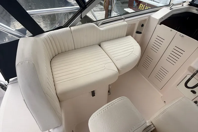 Slide: The Image of 2013 Grady-White Express 330 boat interior with white cushioned seating. - 14