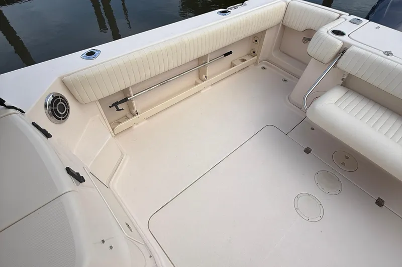 Slide: The Image of 2013 Grady-White Express 330 boat interior with cushioned seating and storage compartments. - 15