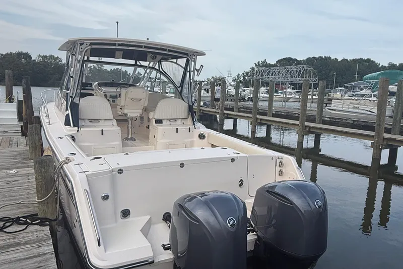 Slide: The Image of 2013 Grady-White Express 330 boat docked with dual outboard engines. - 16