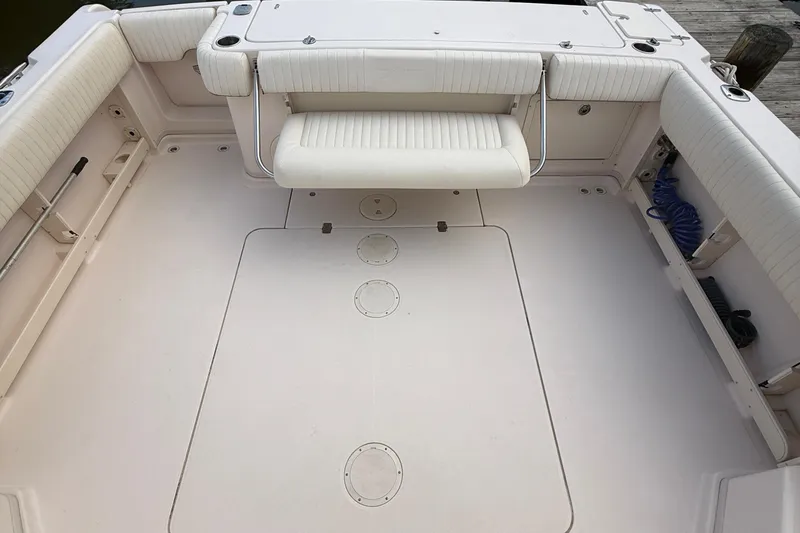 Slide: The Image of 2013 Grady-White Express 330 boat interior with cushioned seating and spacious deck. - 19