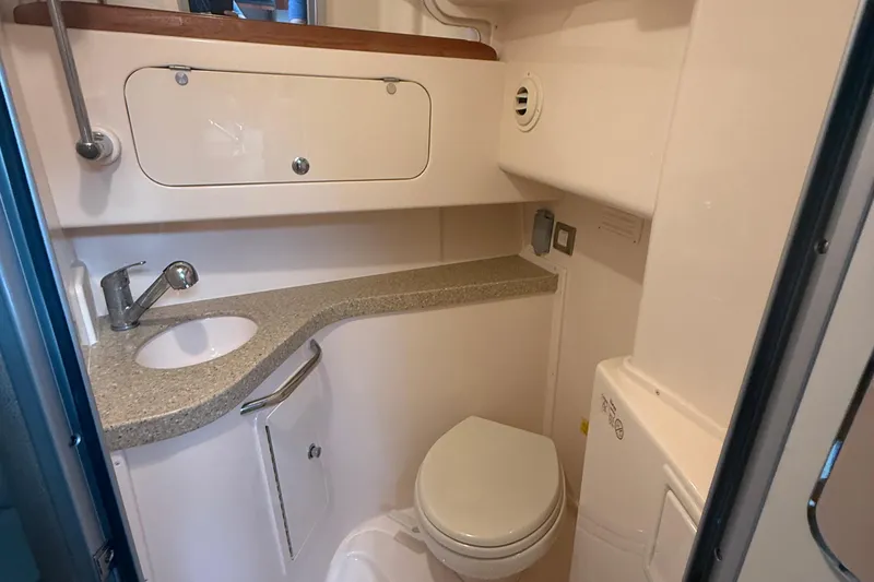 Slide: The Image of 2013 Grady-White Express 330 boat bathroom with sink, toilet, and storage. - 4