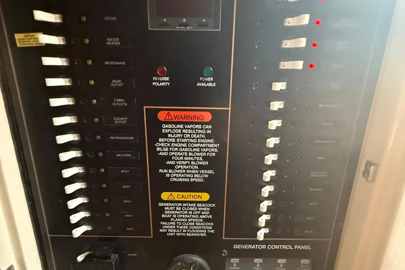 Slide: The Image of Control panel of a 2013 Grady-White Express 330 boat with various switches and warnings. - 5