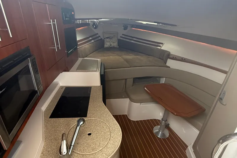 Slide: The Image of Interior of 2013 Grady-White Express 330 boat with kitchen and seating area. - 7