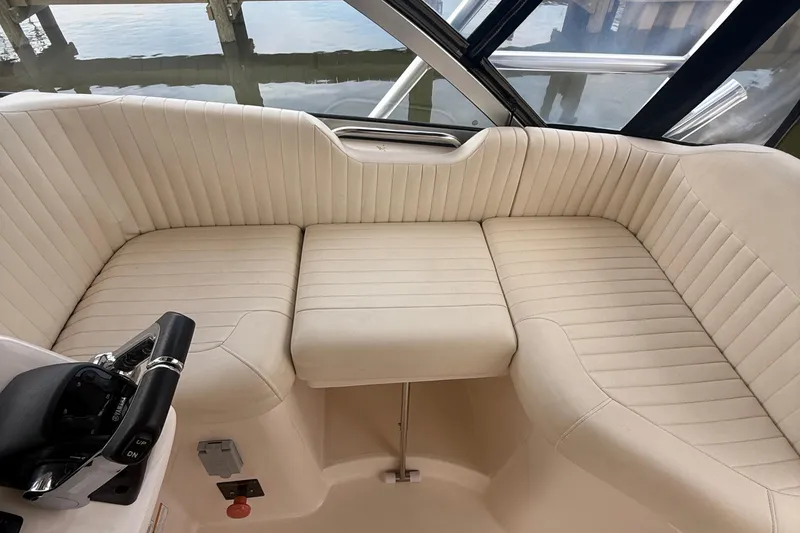 Slide: The Image of 2013 Grady-White Express 330 boat interior with beige seating and control panel. - 9