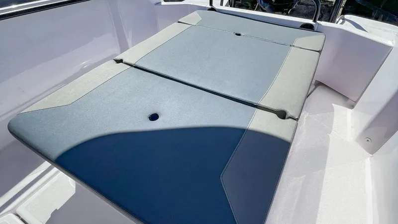 Slide: The Image of 2023 Axopar 22 T-Top boat seating area with gray cushions. - 8