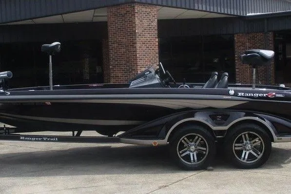 The Image of 2019 Ranger Z520C Carbon Comanche boat, sleek black design, parked on a trailer. - 1