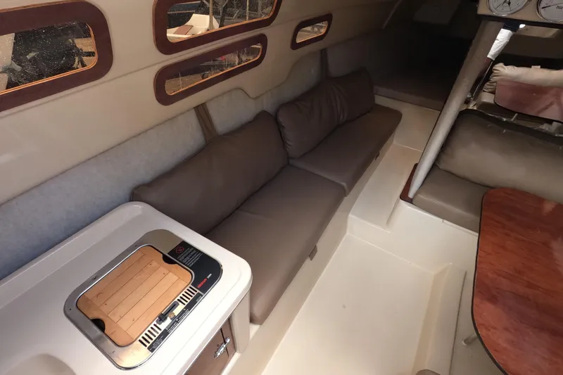 Slide: The Image of Interior of a 2007 MacGregor 26M sailboat with seating and kitchenette. - 11
