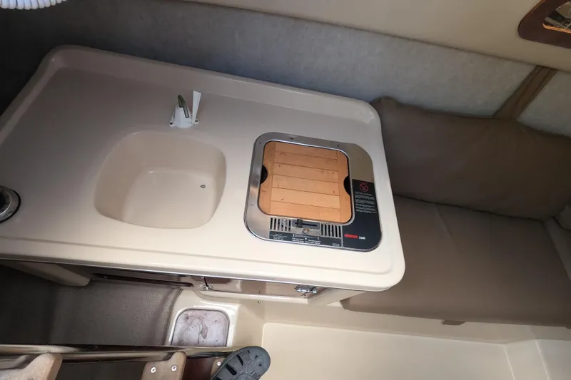 Slide: The Image of Interior of 2007 MacGregor 26M sailboat with sink and stove. - 12