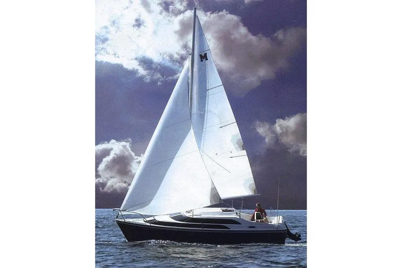 Slide: The Image of 2007 MacGregor 26M sailboat navigating under cloudy skies on open water. - 25