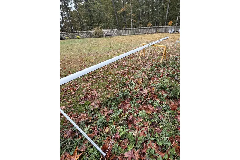 Slide: The Image of Outdoor setup with a long metal beam on wooden supports, surrounded by autumn leaves. - 27