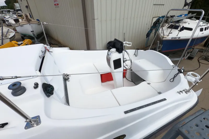 Slide: The Image of 2007 MacGregor 26M sailboat cockpit with steering wheel and seating area. - 5