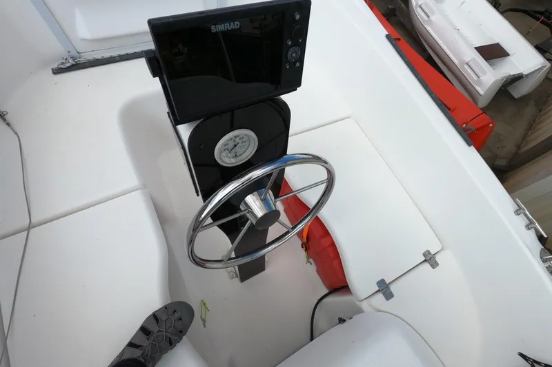 Slide: The Image of Steering wheel and navigation system on 2007 MacGregor 26M sailboat deck. - 7