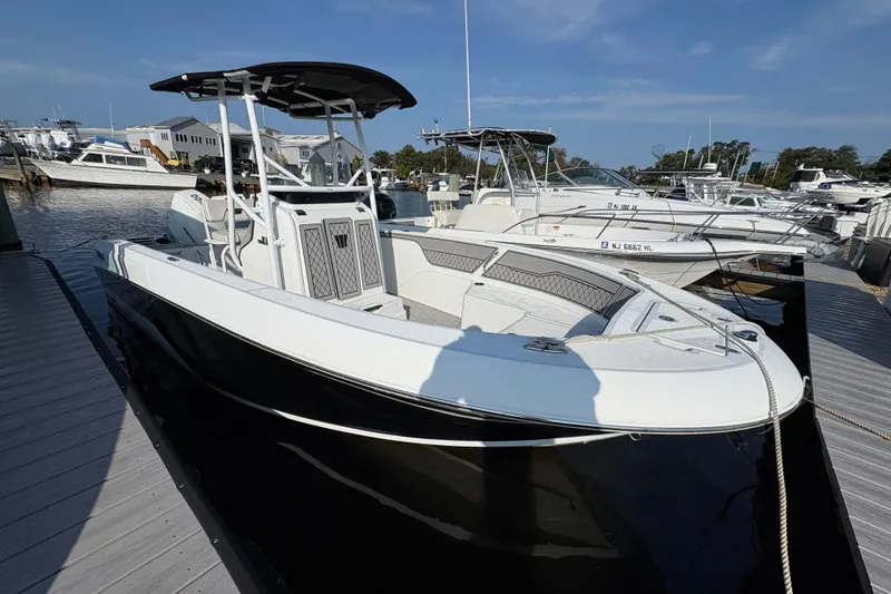 Slide: The Image of 2021 Wellcraft 202 Fisherman boat docked at marina, featuring sleek design and modern amenities. - 2
