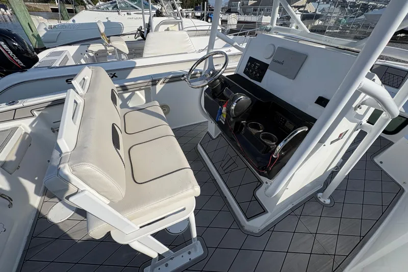 Slide: The Image of 2021 Wellcraft 202 Fisherman boat interior with steering console and seating. - 4