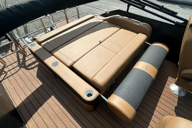 Slide: The Image of 2025 Bentley Pontoons 223 Elite Swingback with tan seating and cup holders on deck. - 13
