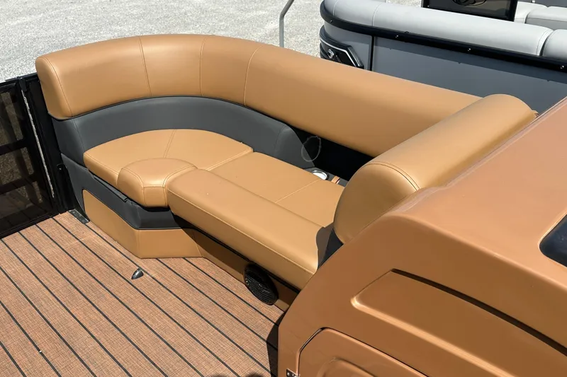 Slide: The Image of 2025 Bentley Pontoons 223 Elite Swingback with tan and gray seating on a wooden deck. - 14