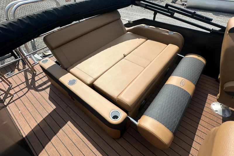 Slide: The Image of 2025 Bentley Pontoons 223 Elite Swingback interior with tan seating and cup holders. - 17