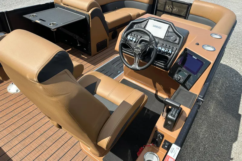 Slide: The Image of 2025 Bentley Pontoons 223 Elite Swingback interior with tan leather seats and modern dashboard. - 18