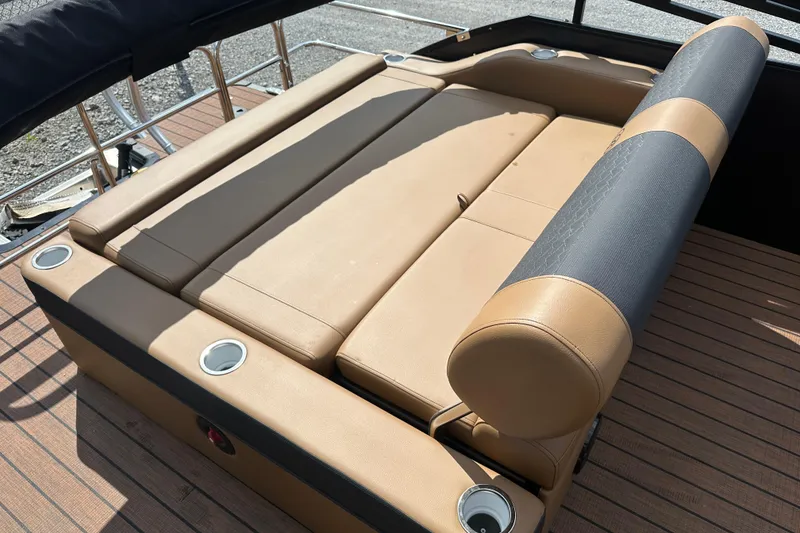 Slide: The Image of 2025 Bentley Pontoons 223 Elite Swingback with luxurious tan seating and cup holders. - 26