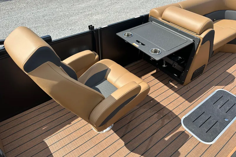 Slide: The Image of 2025 Bentley Pontoons 223 Elite Swingback interior with tan seating and foldable table. - 28