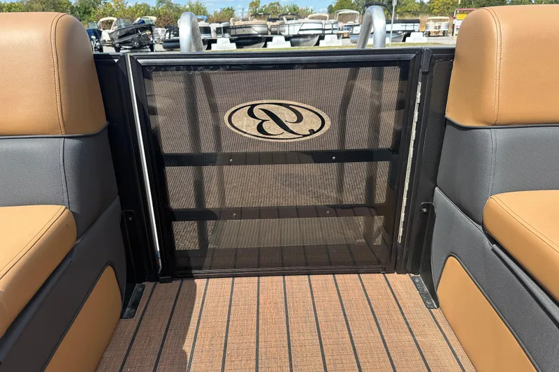 Slide: The Image of 2025 Bentley Pontoons 223 Elite Swingback interior with tan and gray seating. - 7