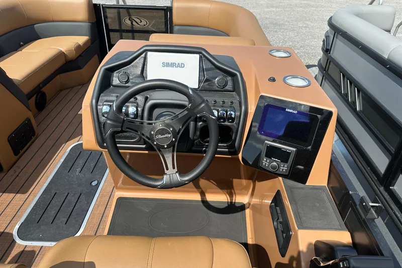 Slide: The Image of 2025 Bentley Pontoons 223 Elite Swingback dashboard with steering wheel and navigation system. - 8