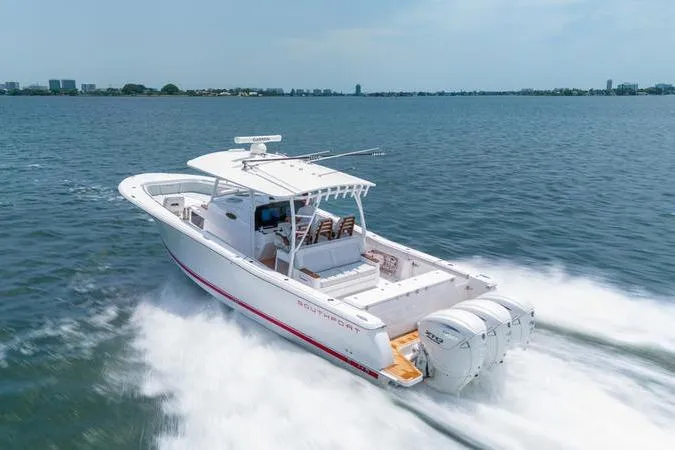 Slide: The Image of 2025 Southport 38 FE boat cruising on open water, showcasing sleek design and powerful engines. - 1