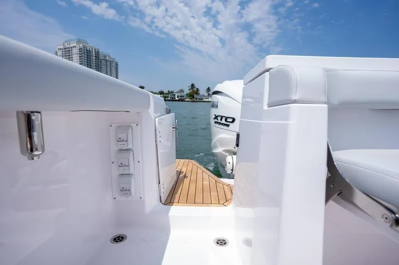 Slide: The Image of 2025 Southport 38 FE boat with Yamaha XTO engine, docked on a sunny day. - 11