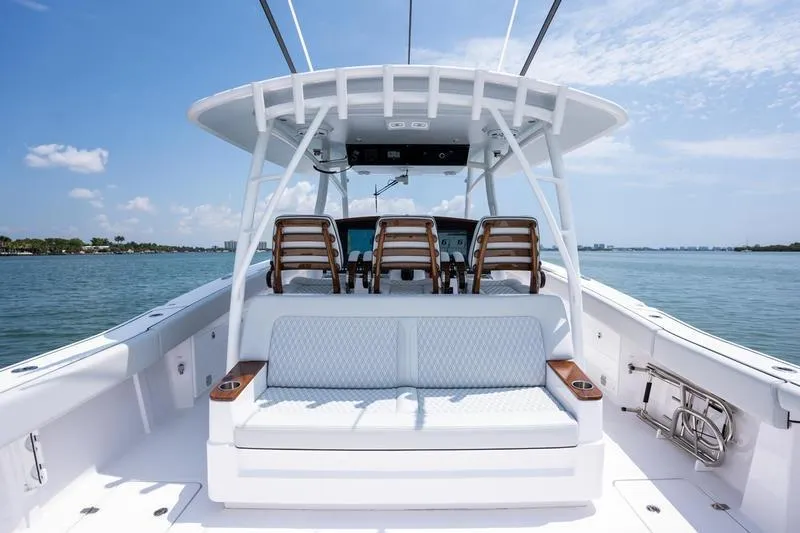 Slide: The Image of 2025 Southport 38 FE boat interior with seating, ocean view, and clear sky. - 15