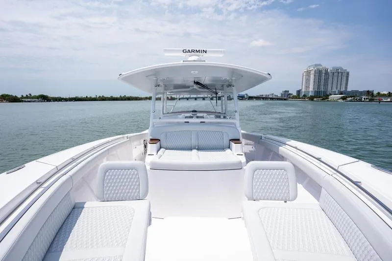 Slide: The Image of 2025 Southport 38 FE boat on water, featuring spacious seating and Garmin equipment. - 19