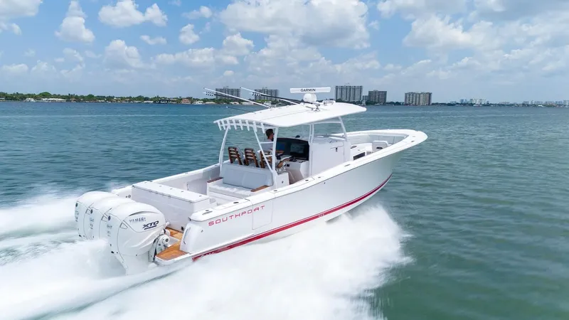 Slide: The Image of 2025 Southport 38FE boat cruising on open water under a clear sky. - 2
