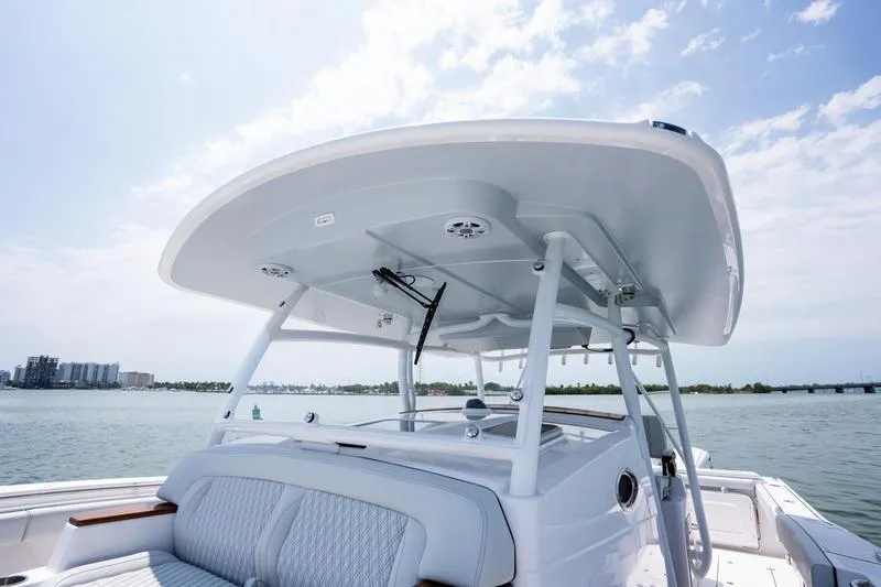 Slide: The Image of 2025 Southport 38 FE boat with sleek design and spacious seating on open water. - 25