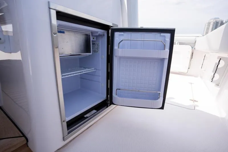 Slide: The Image of Open mini fridge on 2025 Southport 38 FE boat deck, showcasing interior storage. - 26