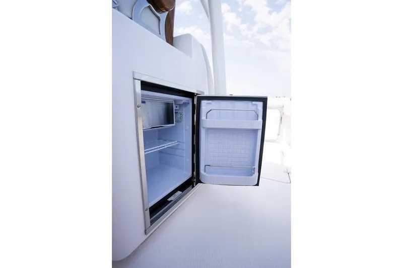 Slide: The Image of Open refrigerator on 2025 Southport 38 FE boat, showcasing interior storage space. - 27