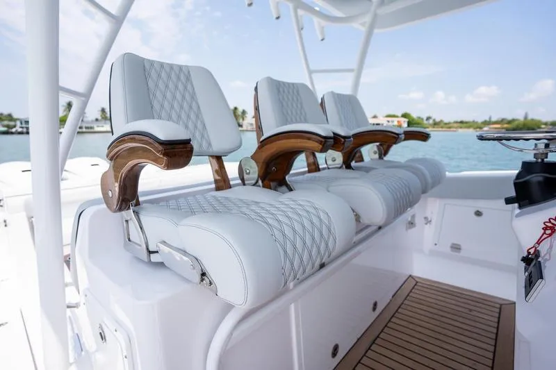 Slide: The Image of Luxury seating on 2025 Southport 38 FE boat, featuring elegant white and wood design. - 3