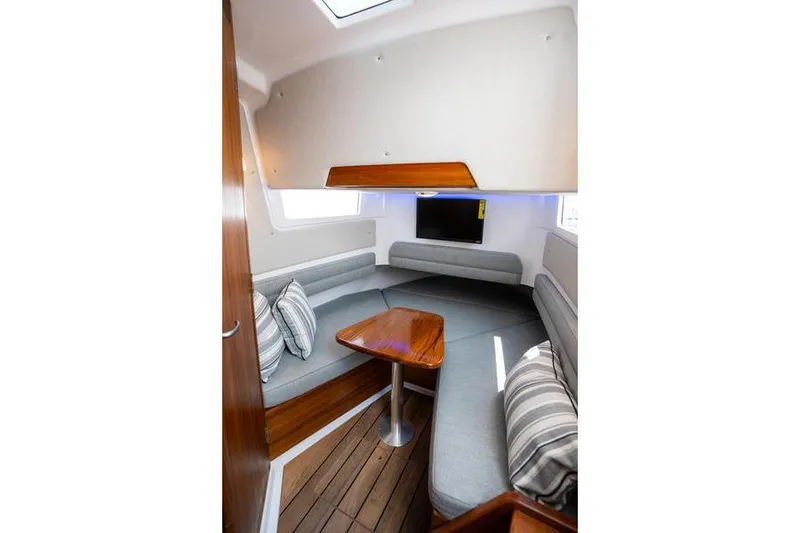 Slide: The Image of 2025 Southport 38 FE cabin interior with cozy seating and wooden table. - 30