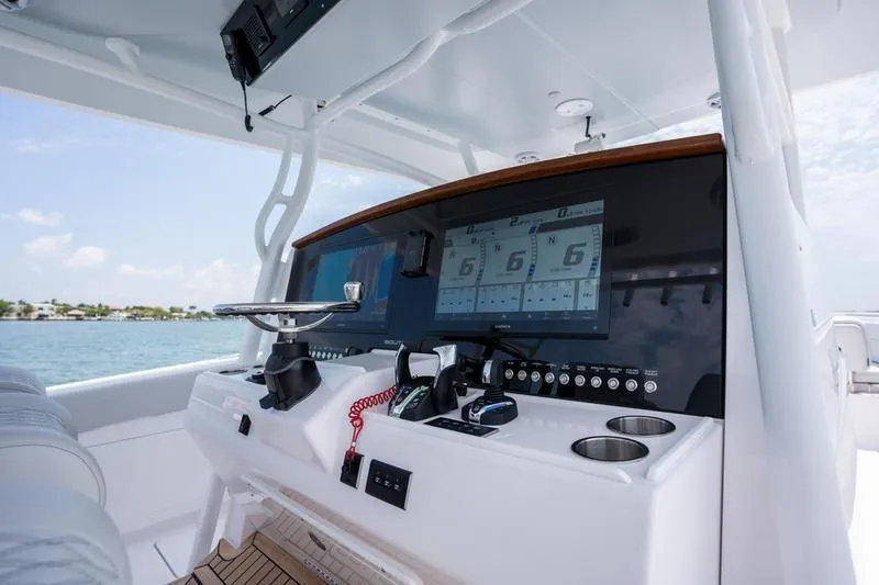 Slide: The Image of 2025 Southport 38 FE boat dashboard with advanced navigation screens and controls. - 4