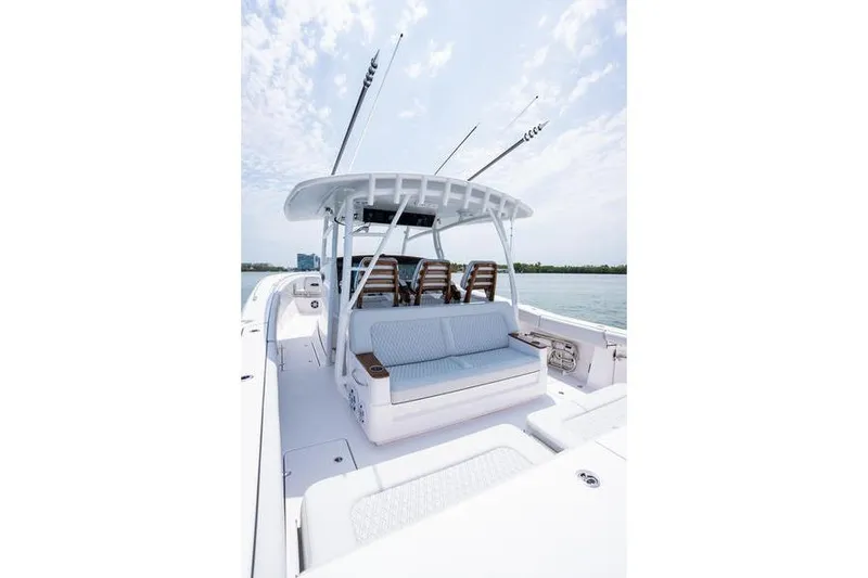 Slide: The Image of 2025 Southport 38 FE boat with seating and fishing rods on a sunny day. - 8