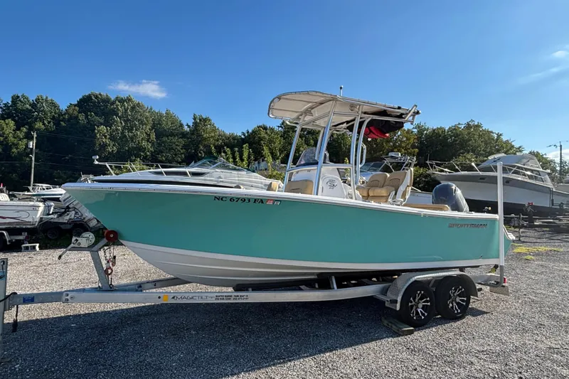 Slide: The Image of 2023 Sportsman Open 212 Center Console boat on trailer, parked outdoors. - 0