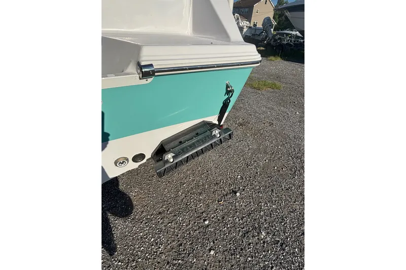Slide: The Image of 2023 Sportsman Open 212 Center Console boat rear view on gravel. - 1