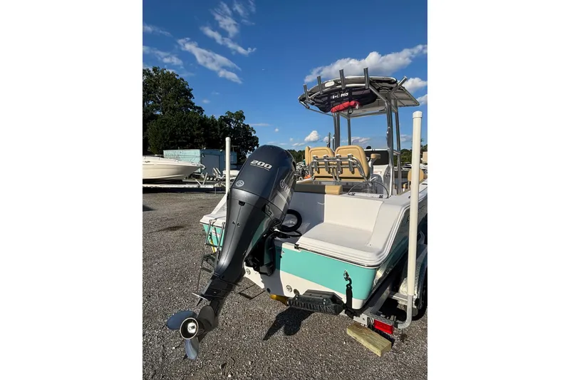 Slide: The Image of 2023 Sportsman Open 212 Center Console boat with powerful outboard motor. - 2