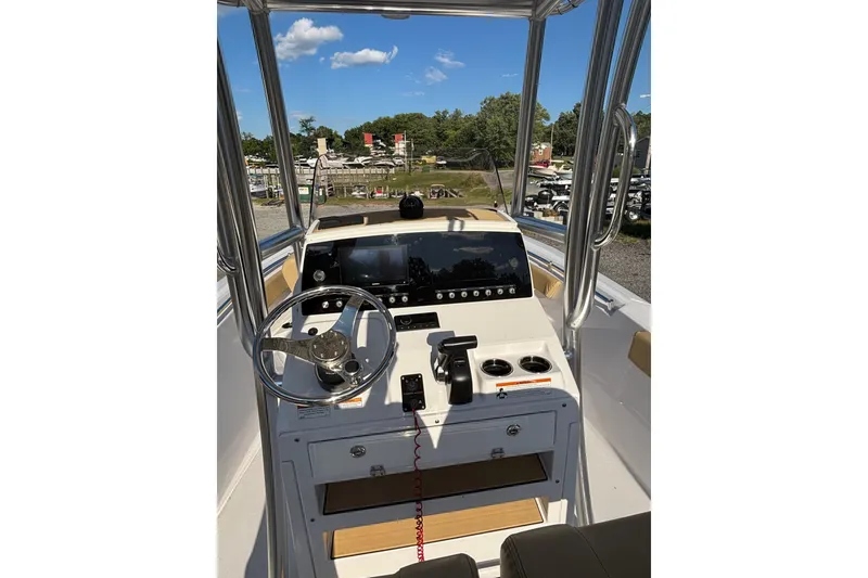 Slide: The Image of 2023 Sportsman Open 212 Center Console boat interior with steering wheel and control panel. - 6