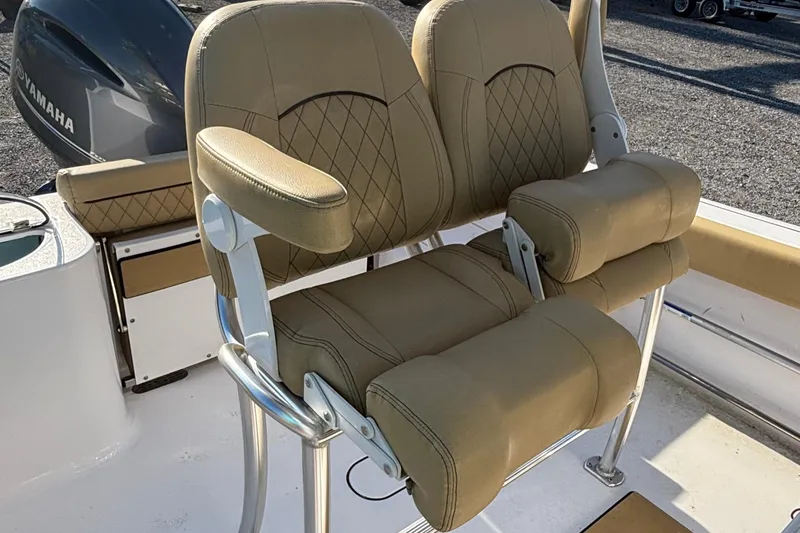 Slide: The Image of 2023 Sportsman Open 212 Center Console boat with tan cushioned seating and Yamaha engine. - 7